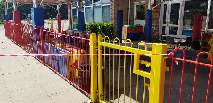 Red and yellow coloured bow gate railings covering the commercial area.